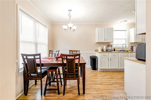 a view of kitchen with cabinets table and chairs