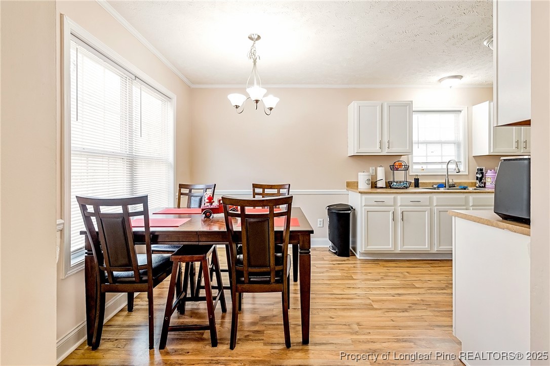 191 Quarry Lane Raeford, NC 28376 - Photo 11 of 28 a view of kitchen with cabinets table and chairs