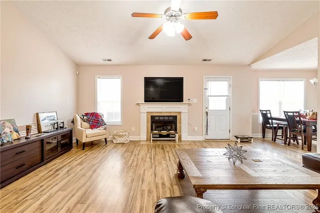 a living room with fireplace furniture and a flat screen tv