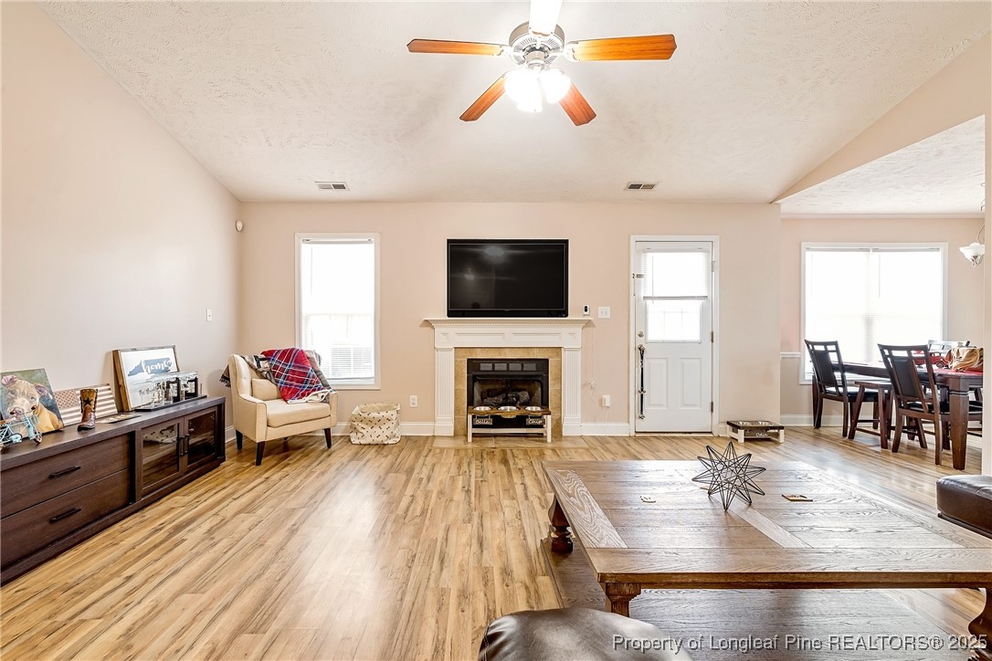 191 Quarry Lane Raeford, NC 28376 - Photo 12 of 28 a living room with fireplace furniture and a flat screen tv