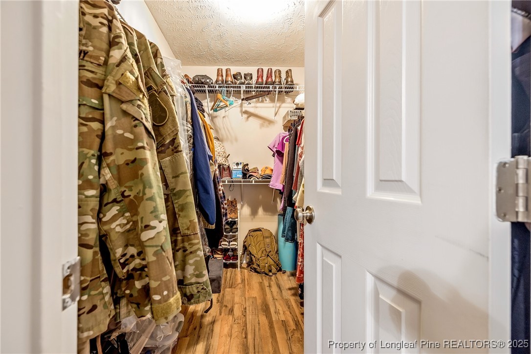 191 Quarry Lane Raeford, NC 28376 - Photo 15 of 28 a view of walk in closet with clothes