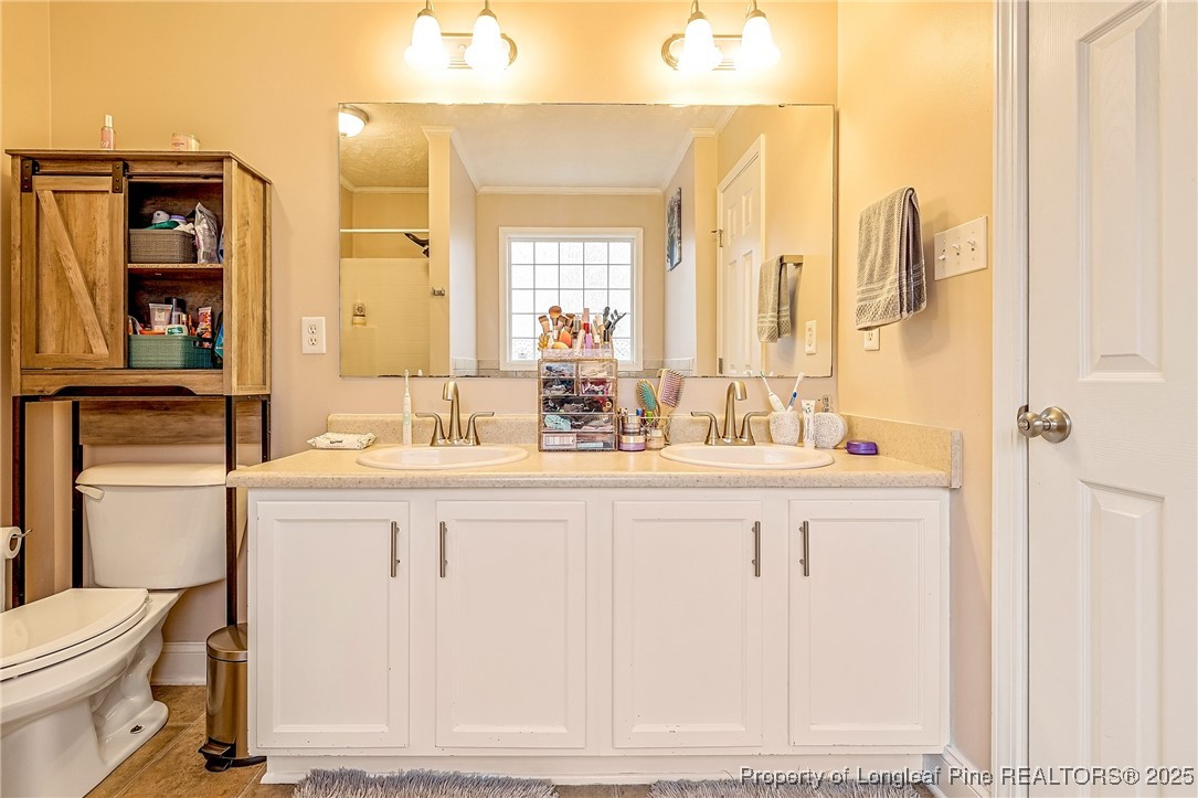 191 Quarry Lane Raeford, NC 28376 - Photo 17 of 28 a bathroom with a sink and a mirror