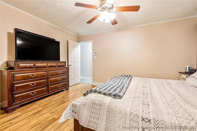 a bedroom with a bed and flat screen tv