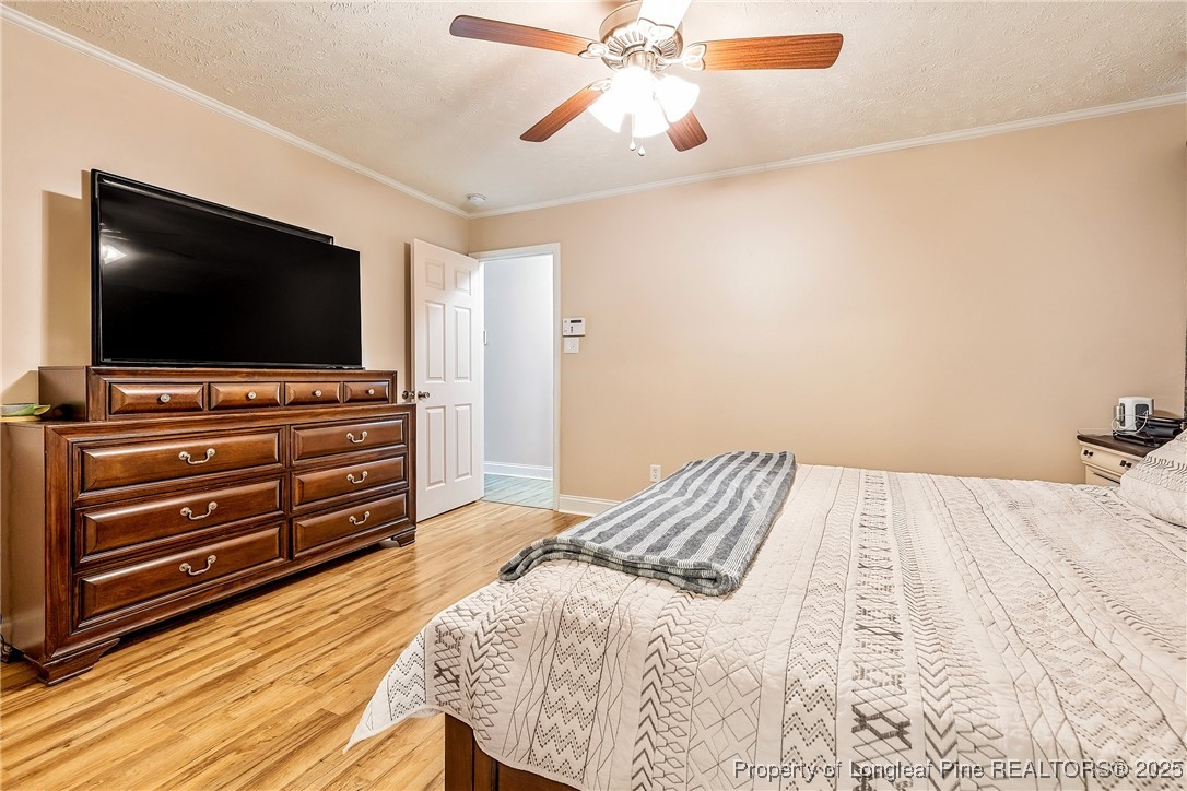 191 Quarry Lane Raeford, NC 28376 - Photo 22 of 28 a bedroom with a bed and flat screen tv