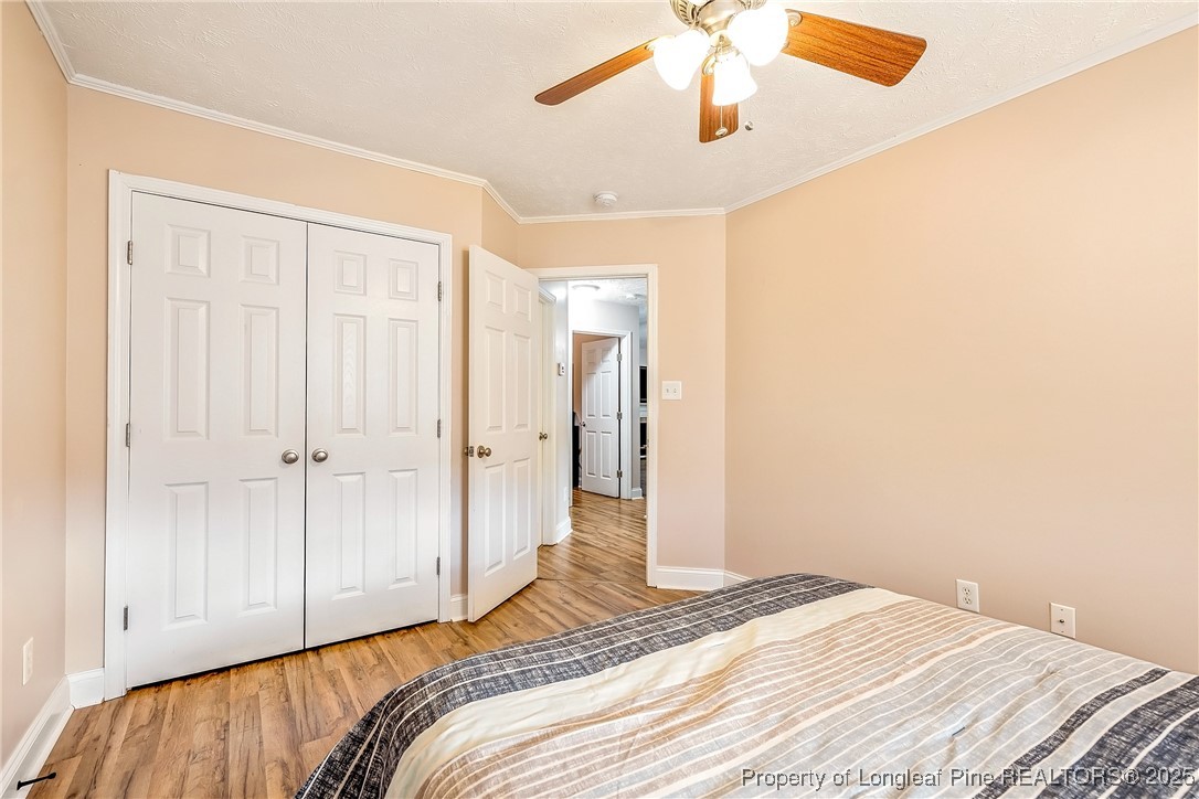 191 Quarry Lane Raeford, NC 28376 - Photo 25 of 28 a bedroom with a bed and a chandelier