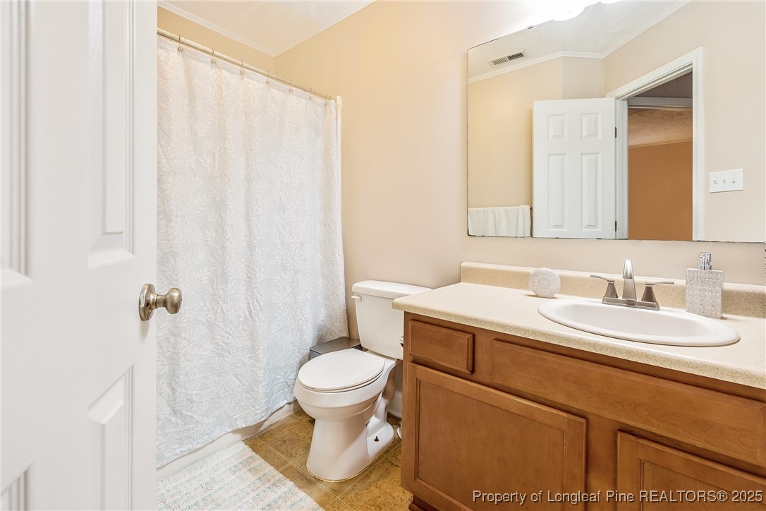 191 Quarry Lane Raeford, NC 28376 - Photo 26 of 28 a bathroom with a sink toilet and shower