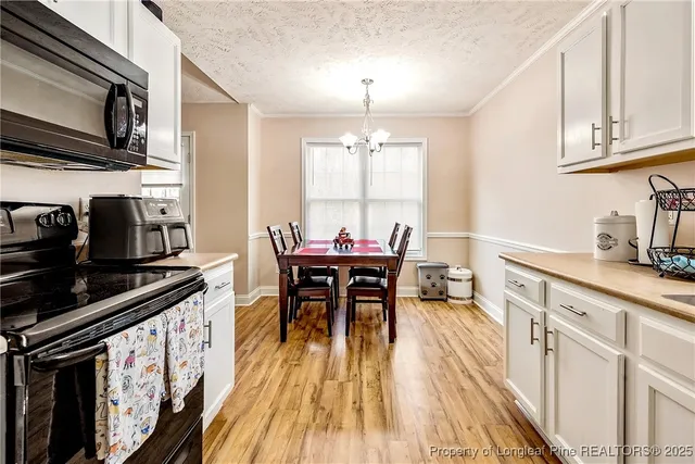 a kitchen with stainless steel appliances a stove a sink dishwasher and cabinets with wooden floor