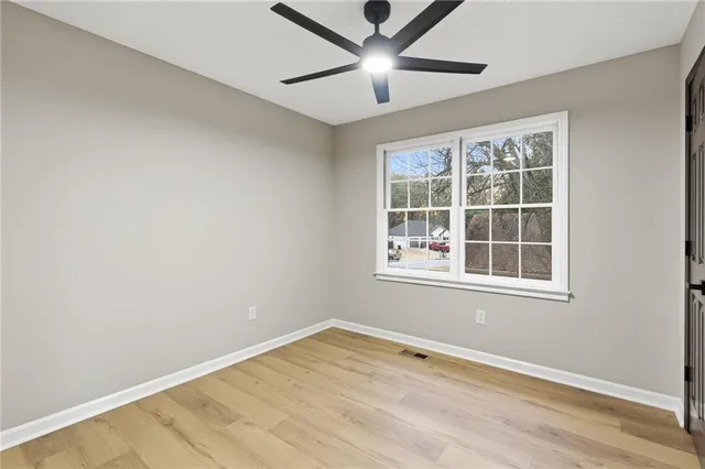 a view of a room with wooden floor