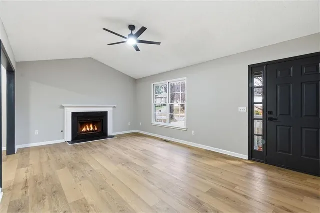 a kitchen with stainless steel appliances granite countertop a stove a sink dishwasher a refrigerator and a microwave oven with cabinets