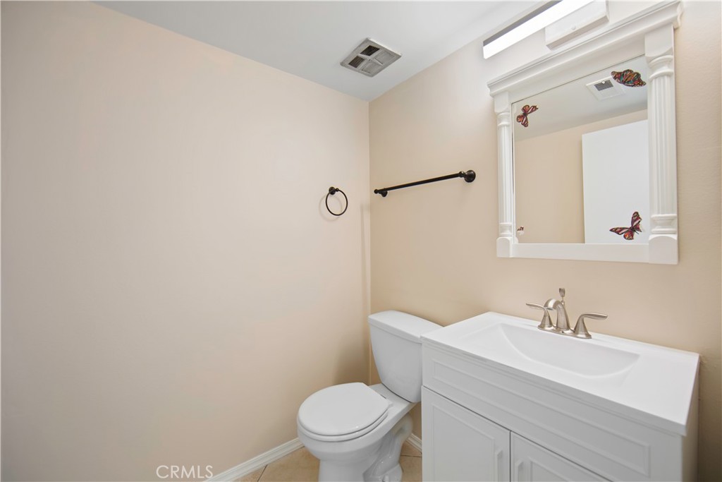 1381 South Walnut Street, Unit 2008 Anaheim, CA 92802 - Photo 17 of 40 a bathroom with a sink a toilet and a mirror