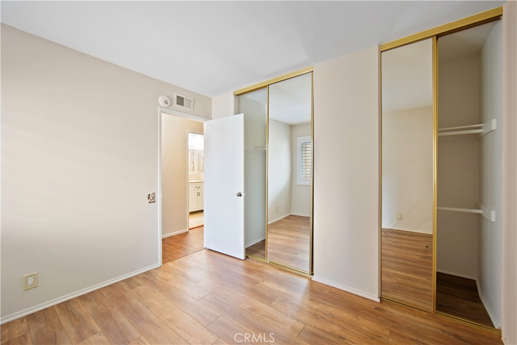 1381 South Walnut Street, Unit 2008 Anaheim, CA 92802 - Photo 19 of 40 a view of an empty room with wooden floor and a bathroom