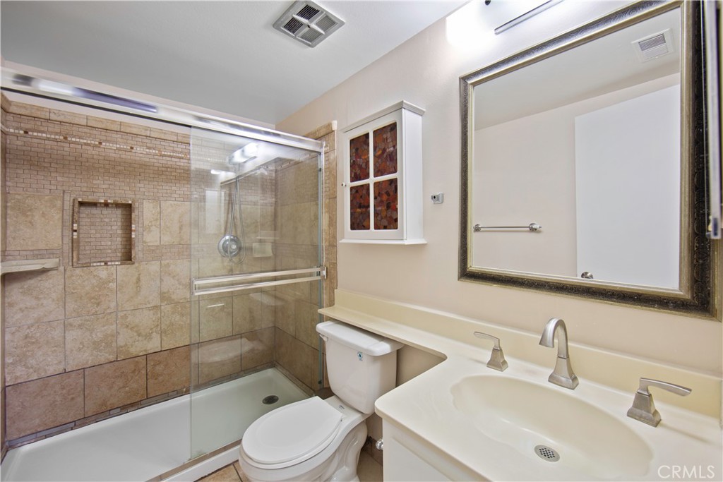 1381 South Walnut Street, Unit 2008 Anaheim, CA 92802 - Photo 26 of 40 a bathroom with a sink a toilet and shower