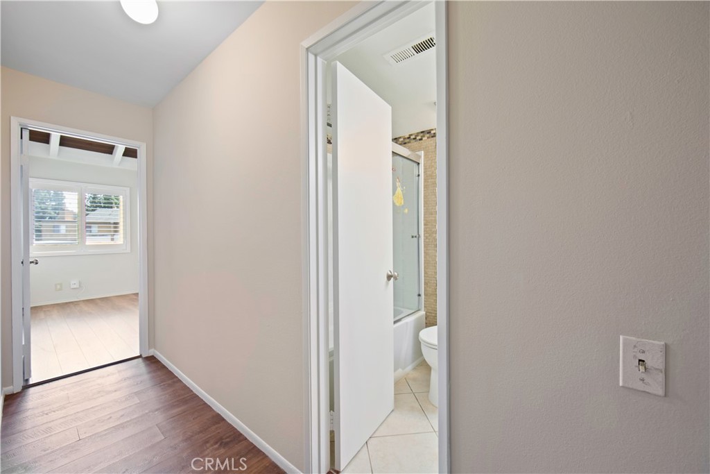 1381 South Walnut Street, Unit 2008 Anaheim, CA 92802 - Photo 28 of 40 a view of an empty room with wooden floor and a bathroom