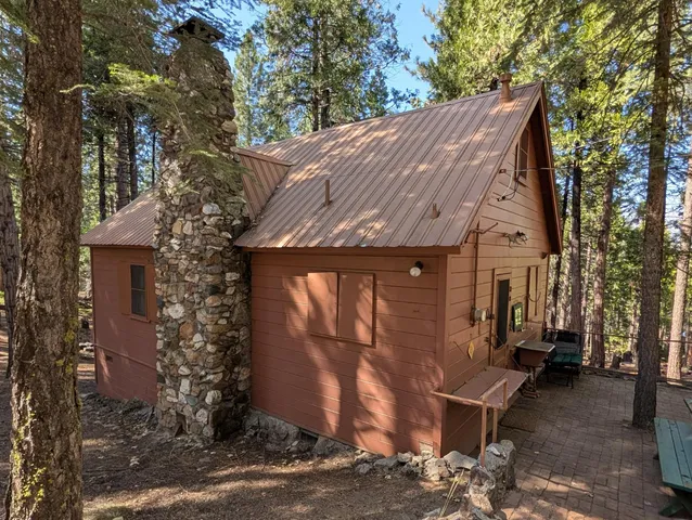 a view of a yard with wooden fence