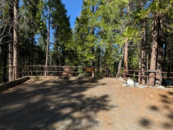 a living room with furniture a chandelier and large window