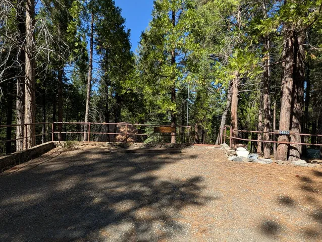 a living room with furniture a chandelier and large window