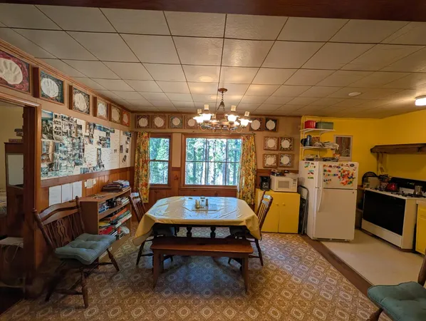 a living room with furniture a fireplace and a chandelier