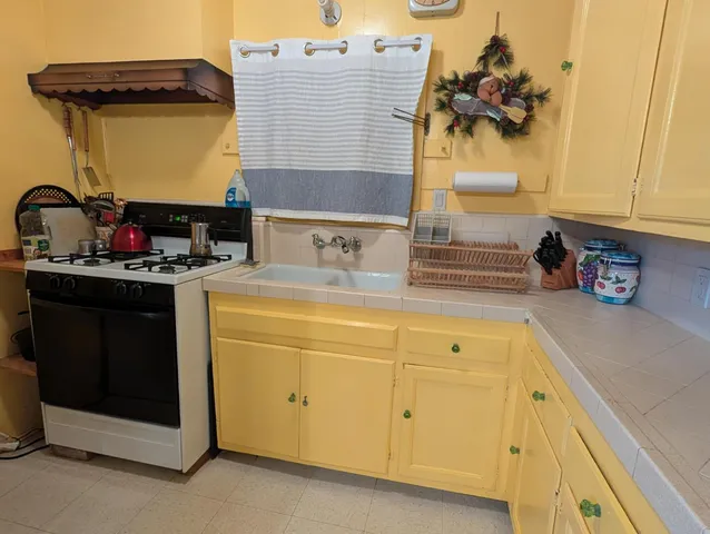 a room with lots of appliances and a chandelier