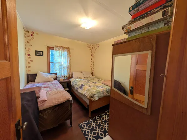 a bedroom with two beds and a window