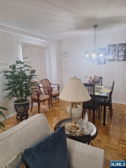 280 Prospect, Unit 9H Hackensack, NJ 07601 - Photo 19 of 38 a living room with furniture a chandelier and a dining table