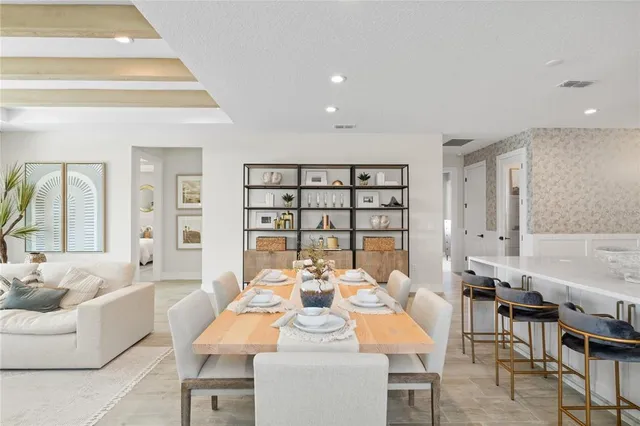 a view of a dining room with furniture and chandelier