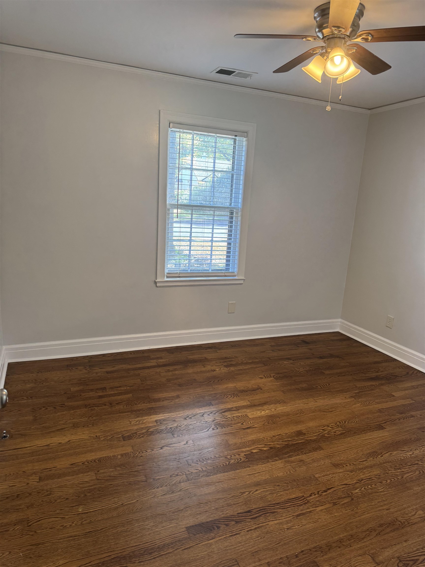 193 Alexander Street Memphis, TN 38111 - Photo 15 of 25 a view of an empty room with window and wooden floor