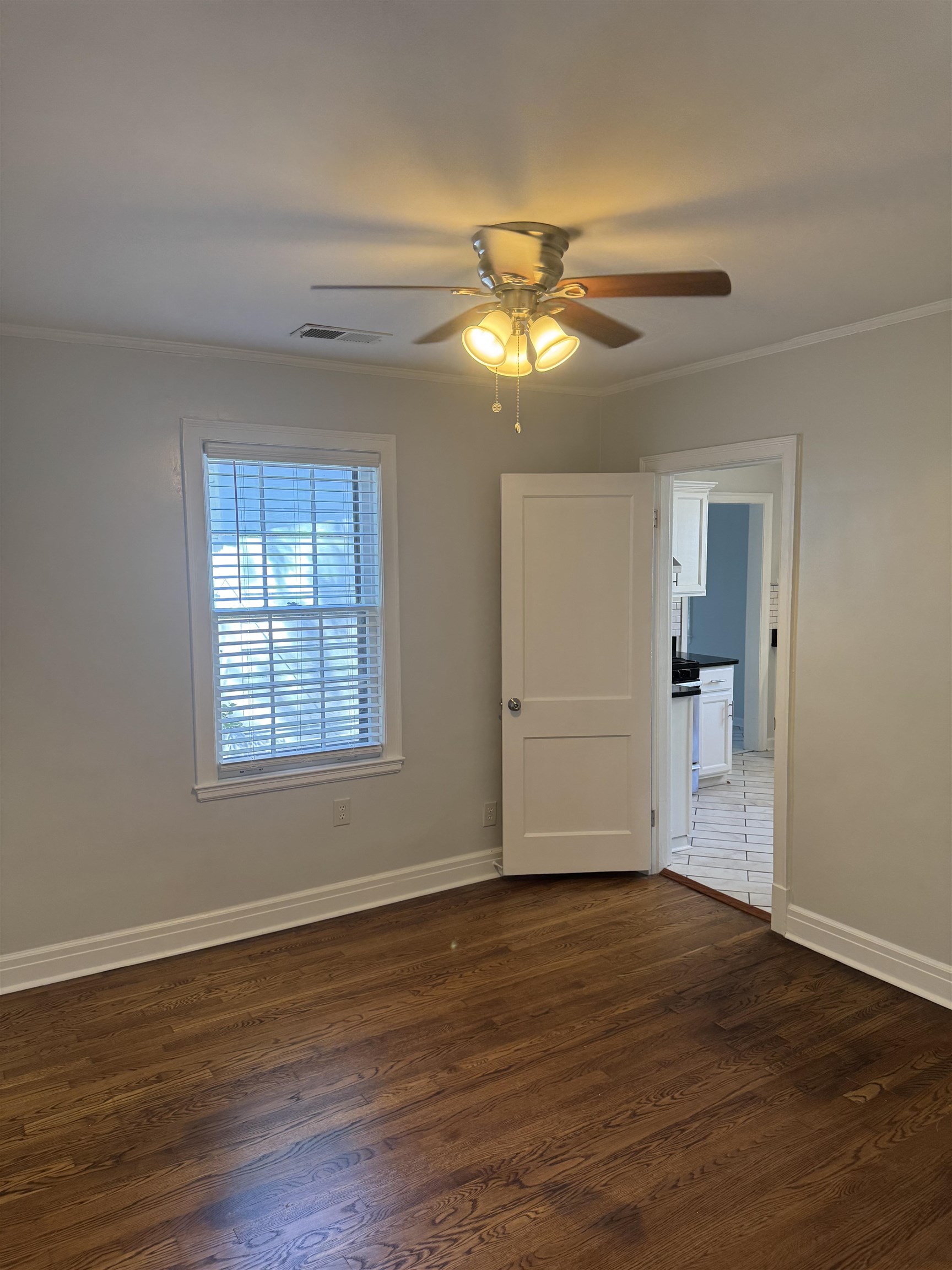 193 Alexander Street Memphis, TN 38111 - Photo 19 of 25 a view of an empty room with wooden floor and a window