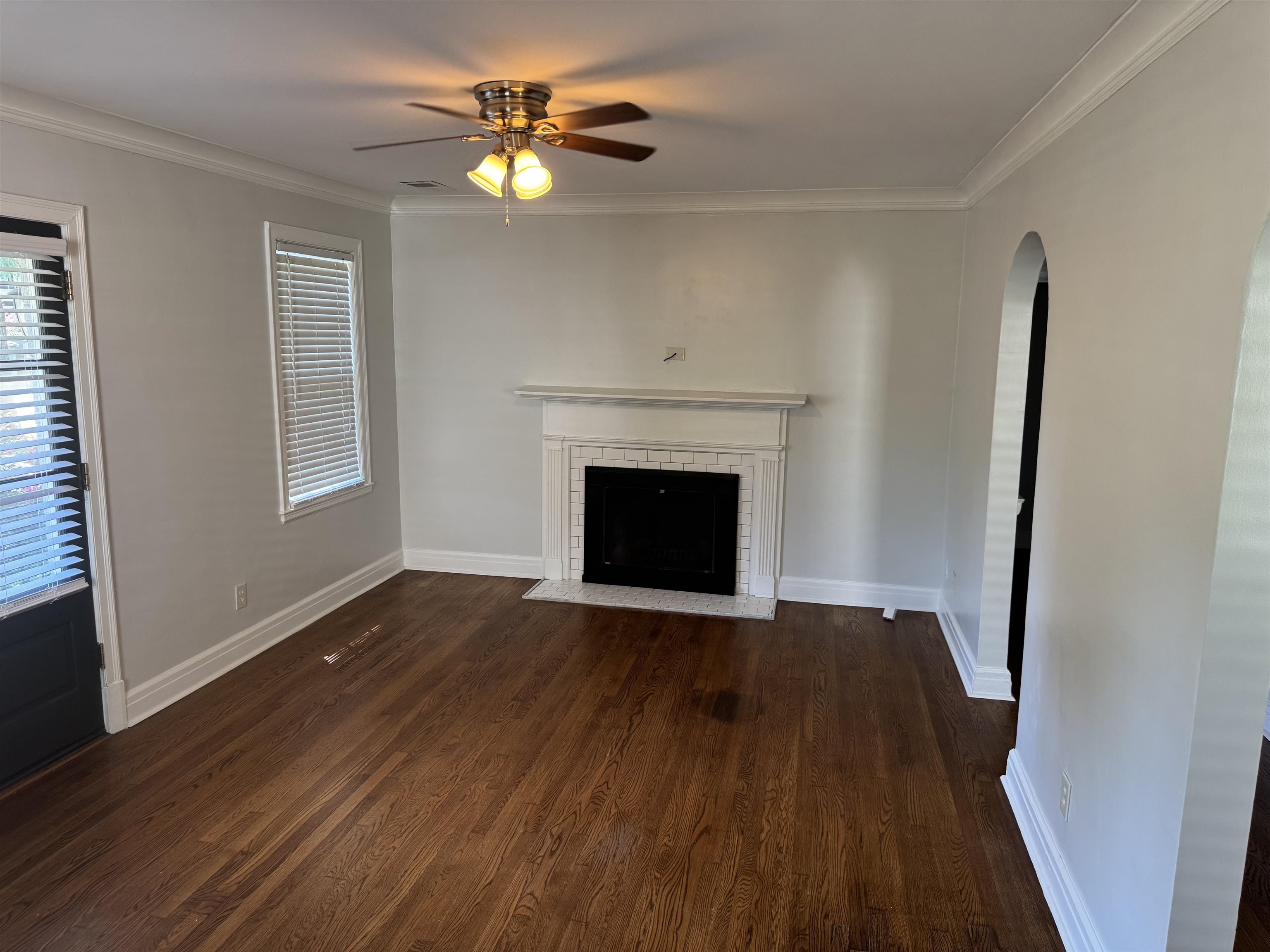 193 Alexander Street Memphis, TN 38111 - Photo 4 of 25 an empty room with wooden floor a fireplace and windows