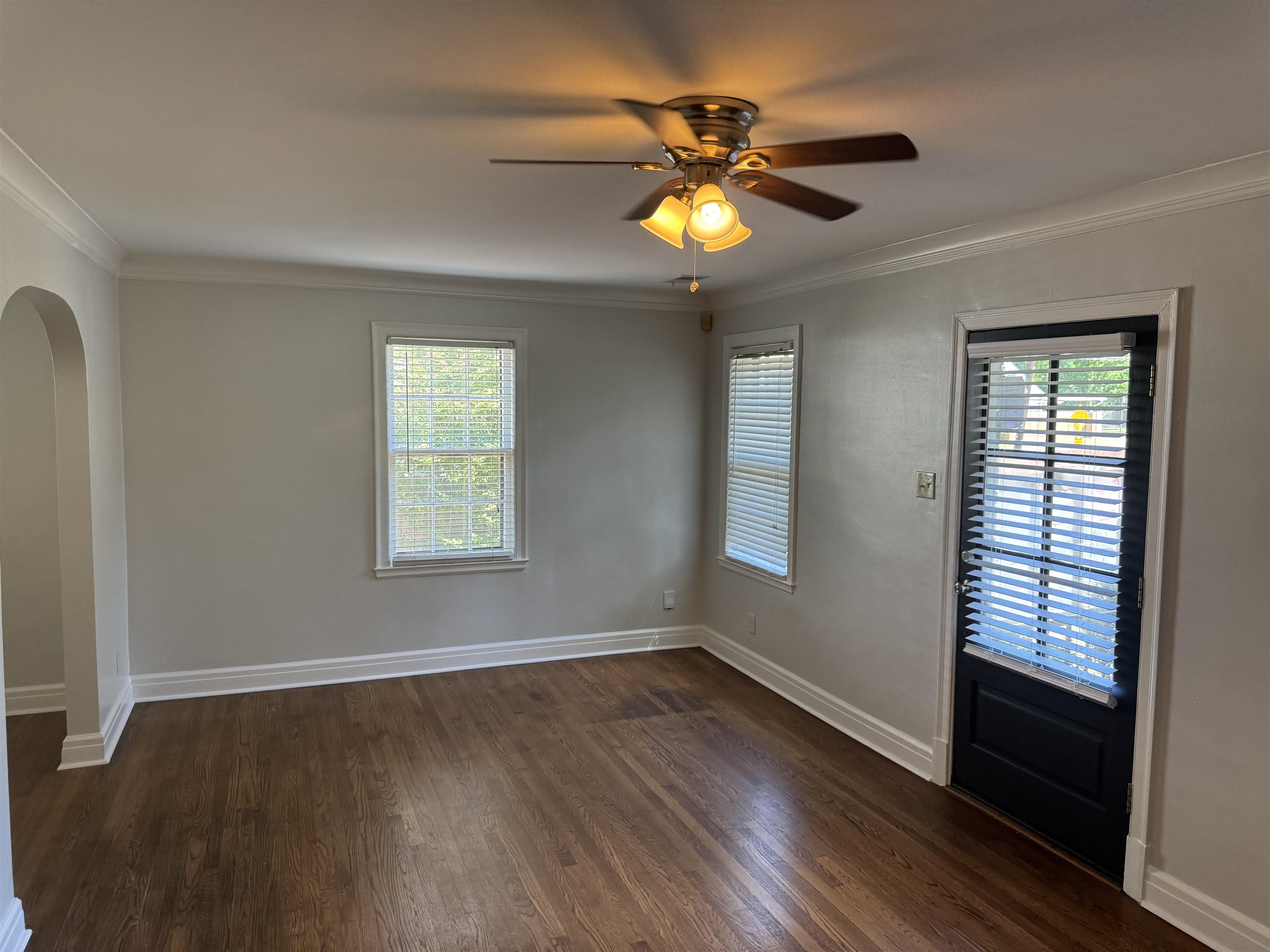 193 Alexander Street Memphis, TN 38111 - Photo 5 of 25 a view of an empty room with wooden floor and a window