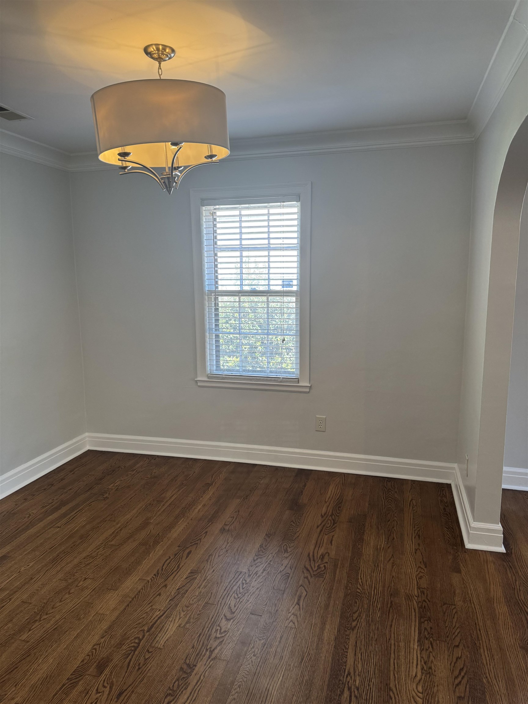 193 Alexander Street Memphis, TN 38111 - Photo 6 of 25 an empty room with wooden floor a chandelier and windows