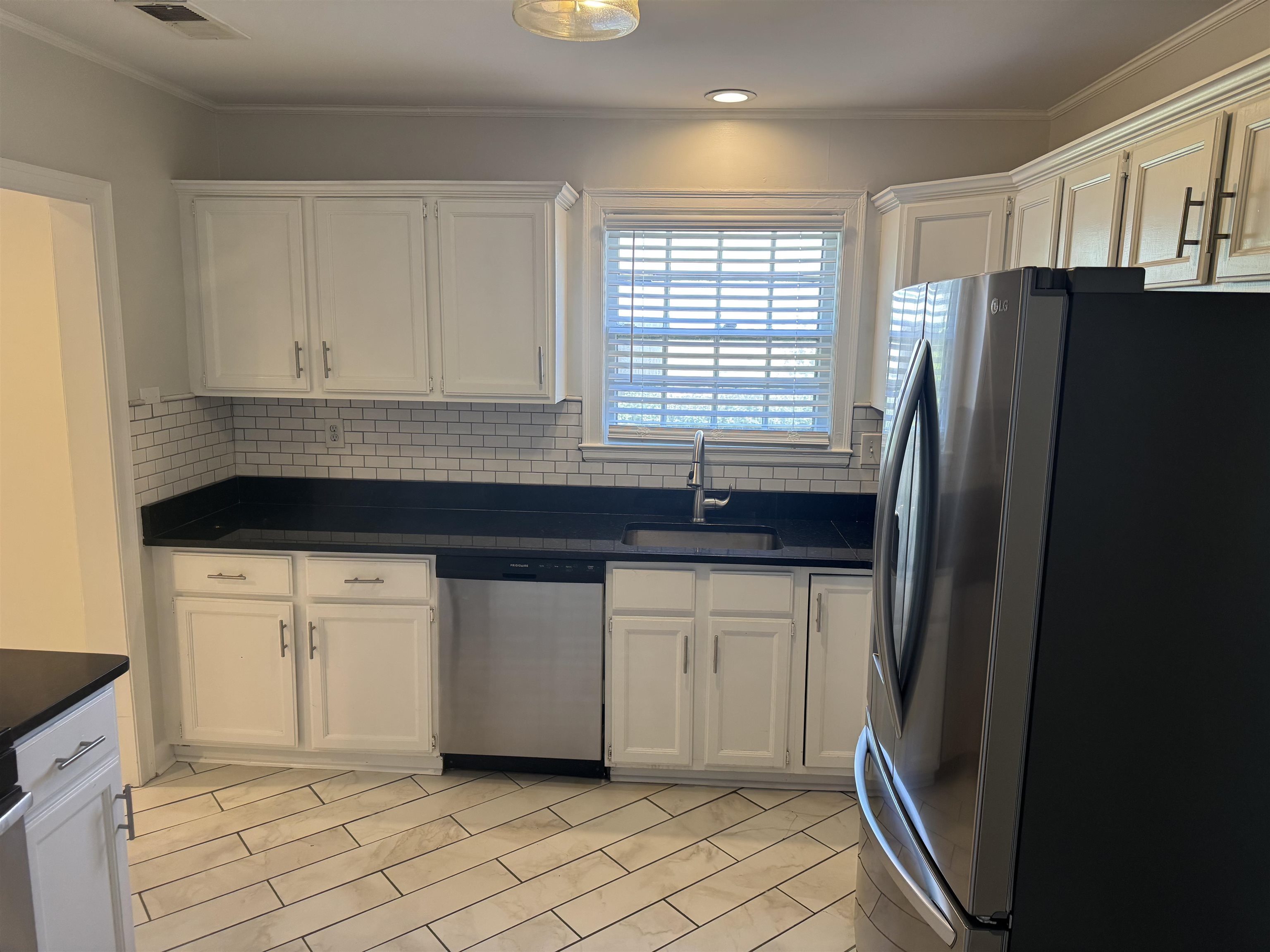 193 Alexander Street Memphis, TN 38111 - Photo 8 of 25 a kitchen with granite countertop a refrigerator sink and cabinets