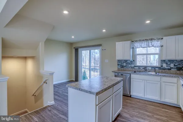 a kitchen with granite countertop a sink and stove