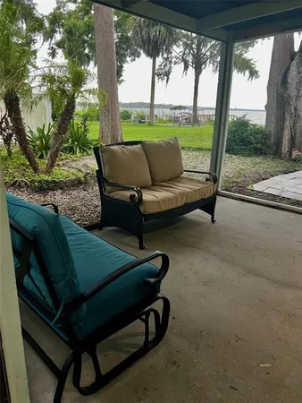 a backyard of a house with a table and chairs