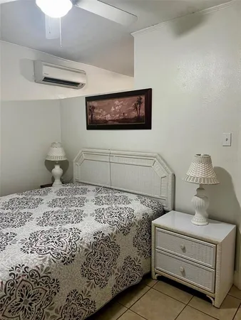 a bedroom with a bed and a painting on the wall