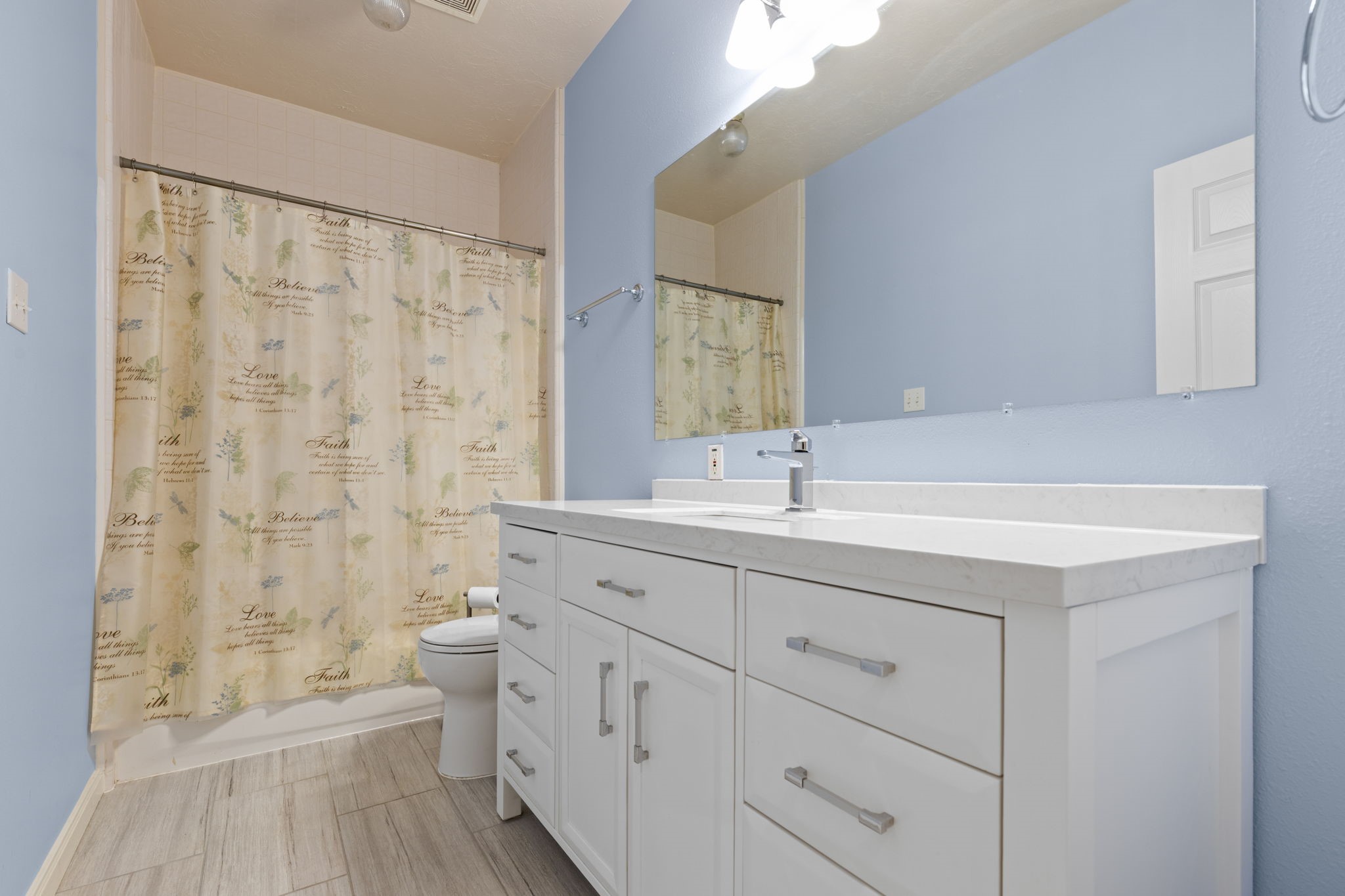 24236 Stuebner Airline Road Tomball, TX 77375 - Photo 25 of 39 a bathroom with a sink a toilet and a large mirror