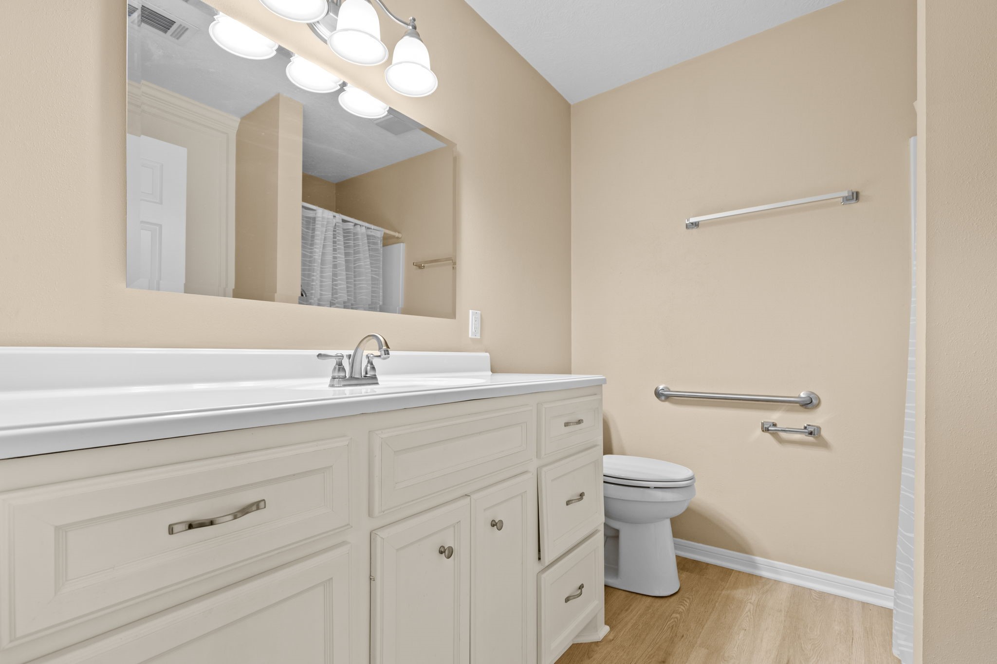 24236 Stuebner Airline Road Tomball, TX 77375 - Photo 29 of 39 a bathroom with a sink a toilet and a mirror