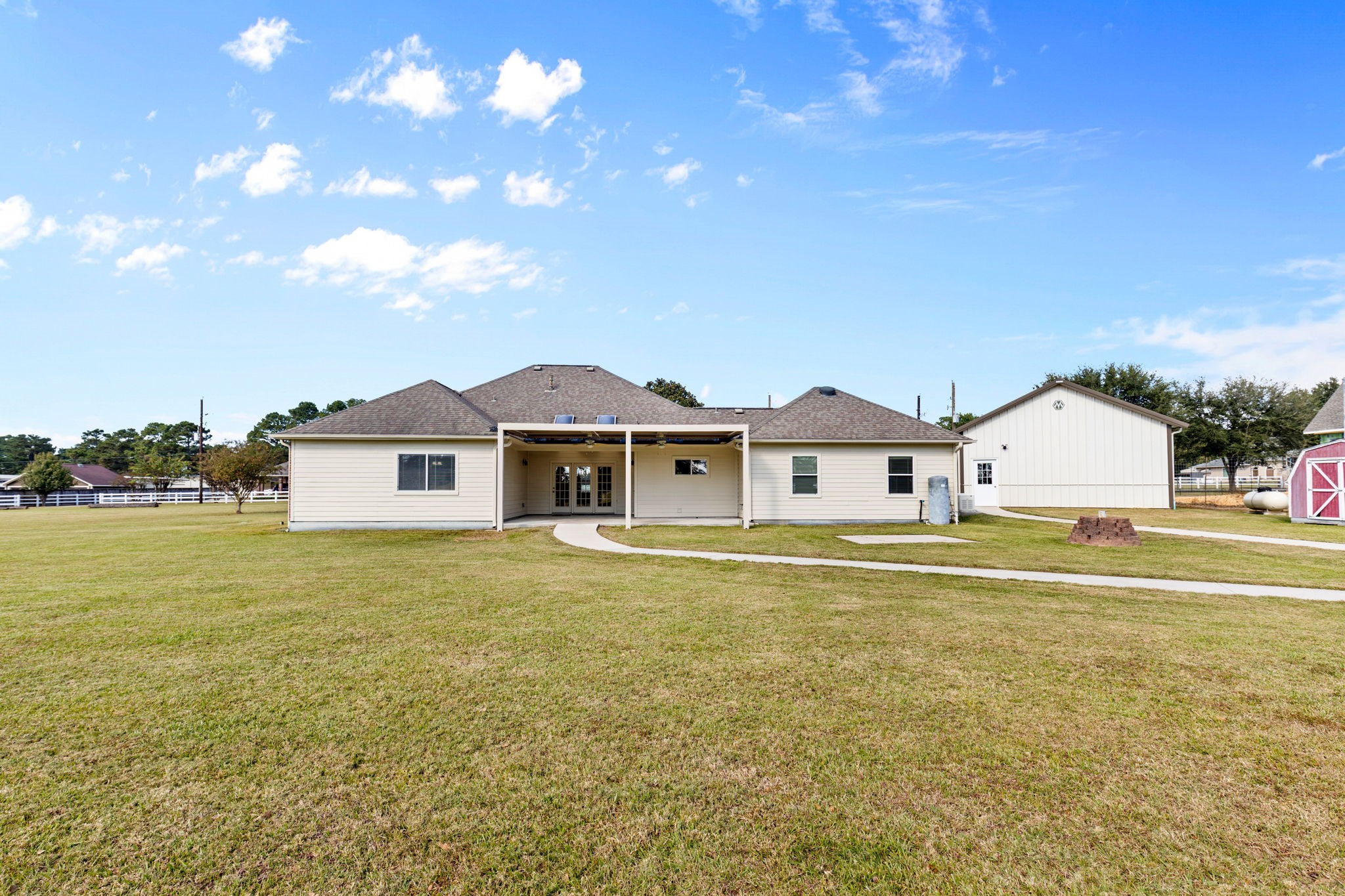 24236 Stuebner Airline Road Tomball, TX 77375 - Photo 30 of 39 a front view of a house with a garden