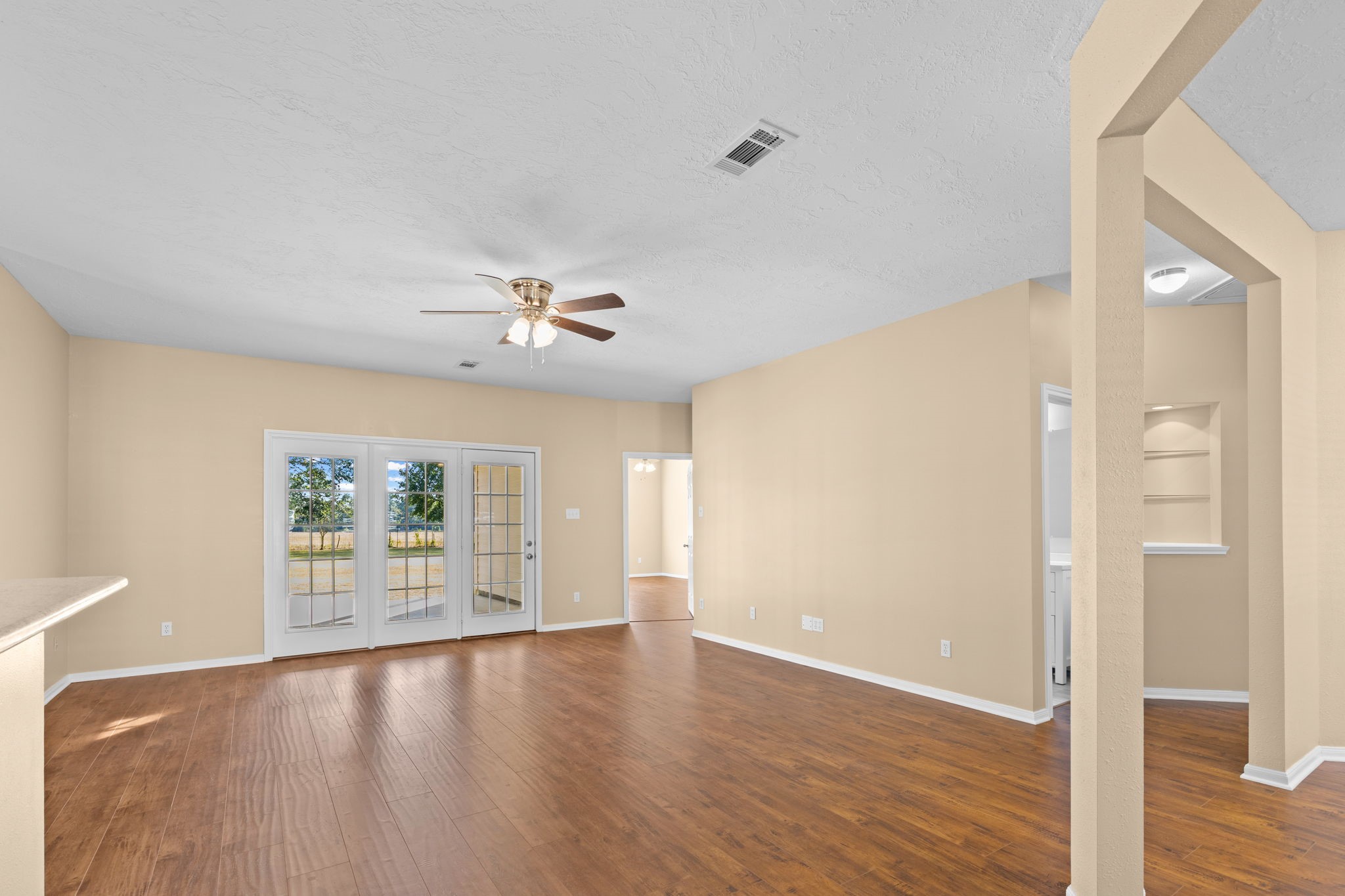 24236 Stuebner Airline Road Tomball, TX 77375 - Photo 6 of 39 wooden floor in an empty room with a window