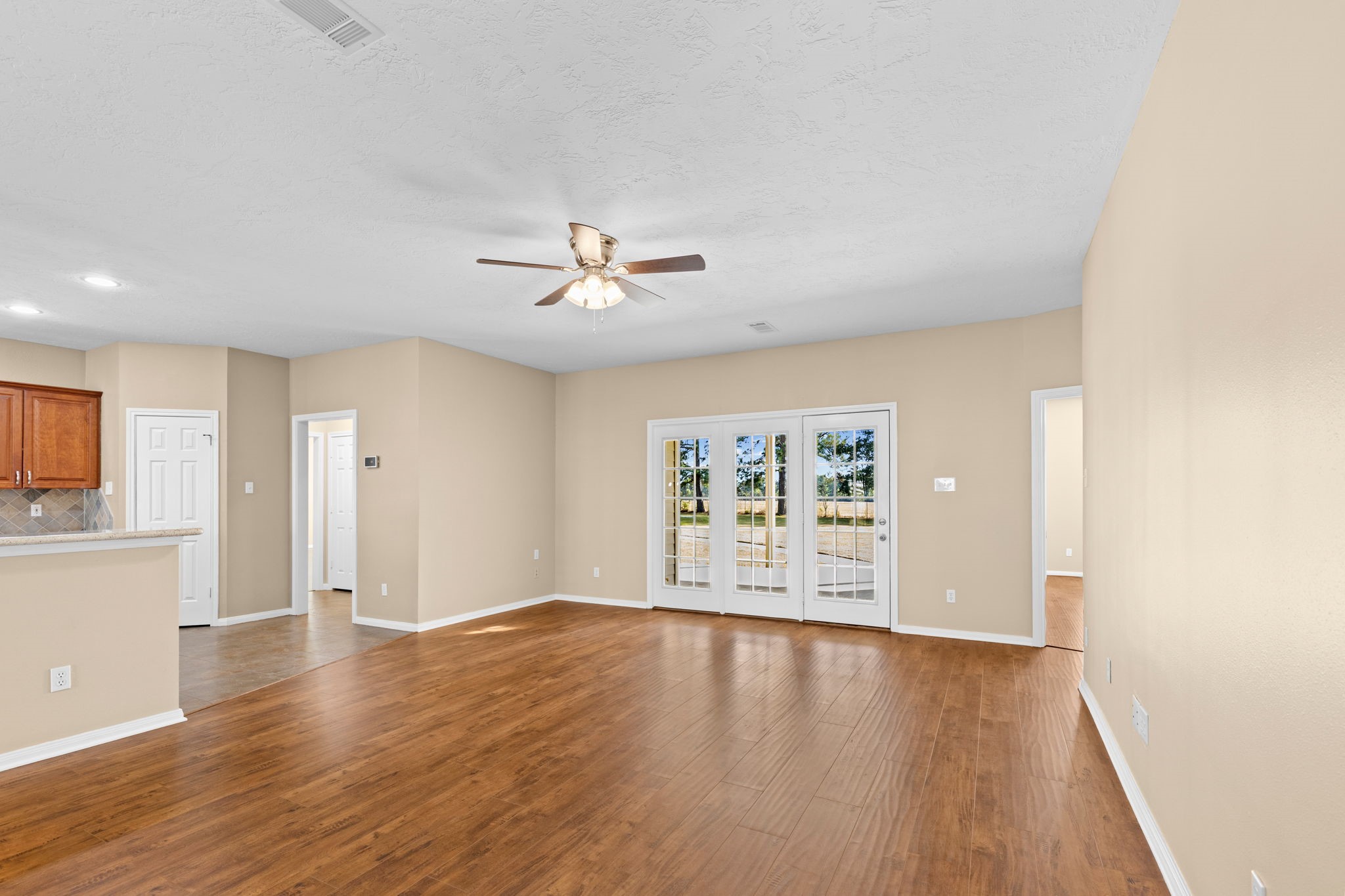 24236 Stuebner Airline Road Tomball, TX 77375 - Photo 7 of 39 a view of an empty room with a window and wooden floor