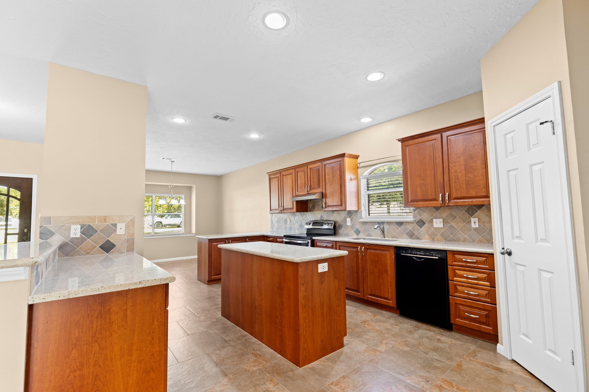 24236 Stuebner Airline Road Tomball, TX 77375 - Photo 8 of 39 a kitchen with a sink a stove and cabinets