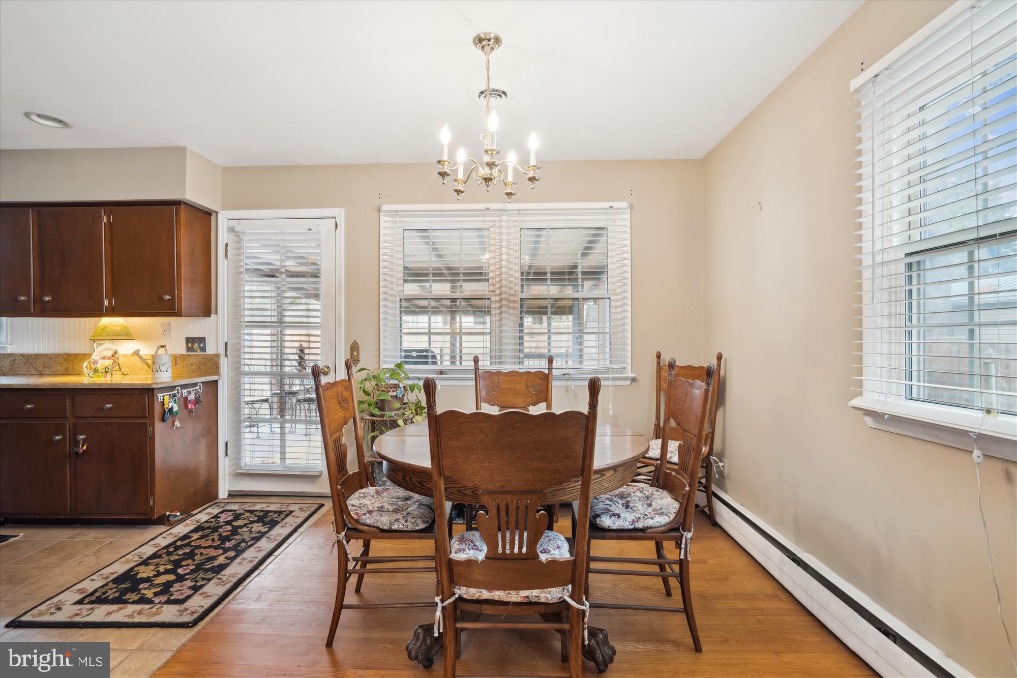 11319 Harding Road Laurel, MD 20723 - Photo 13 of 44 a dining room with furniture a rug and wooden floor