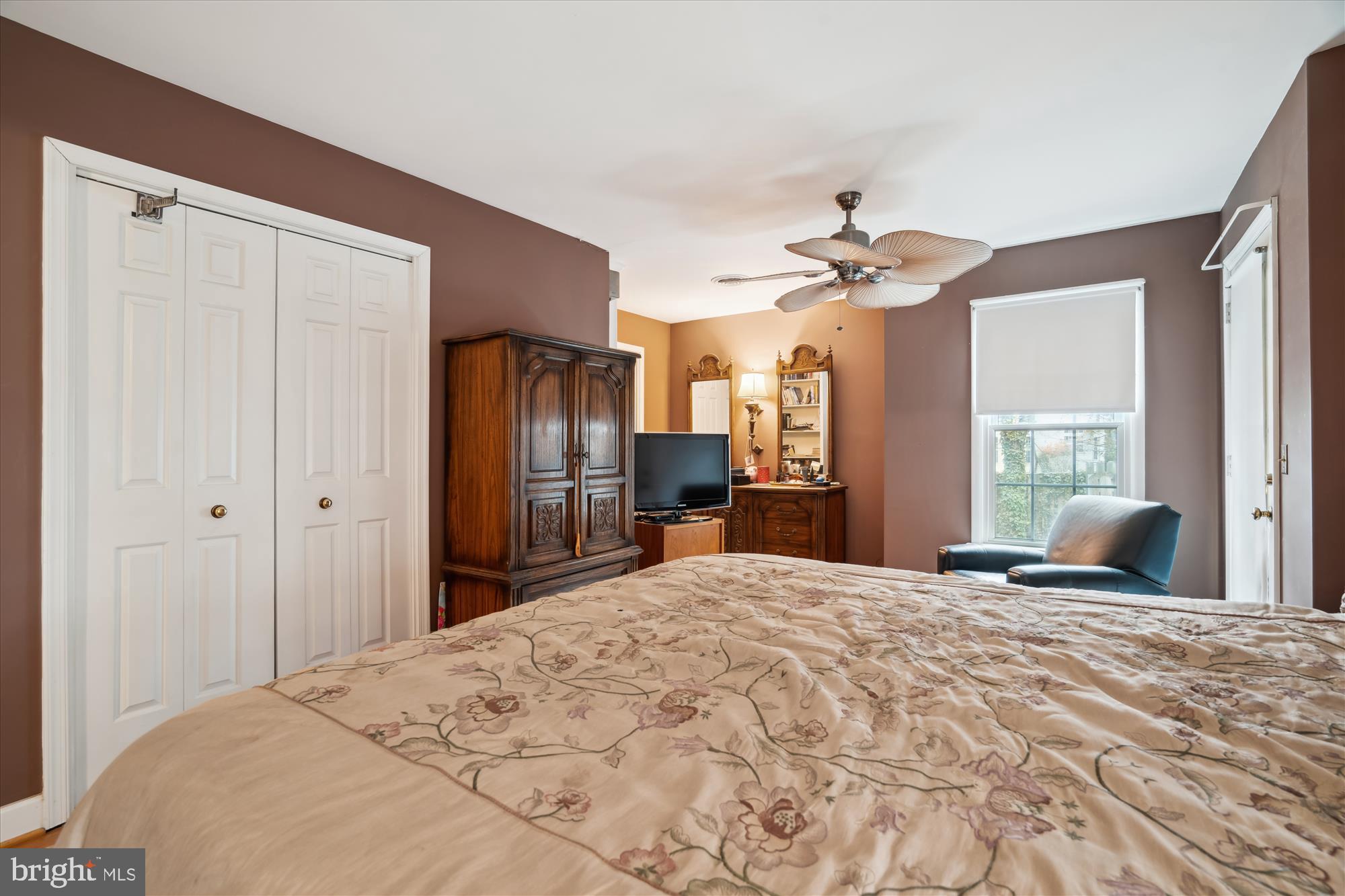 11319 Harding Road Laurel, MD 20723 - Photo 16 of 44 a large bedroom with a bed and a chandelier