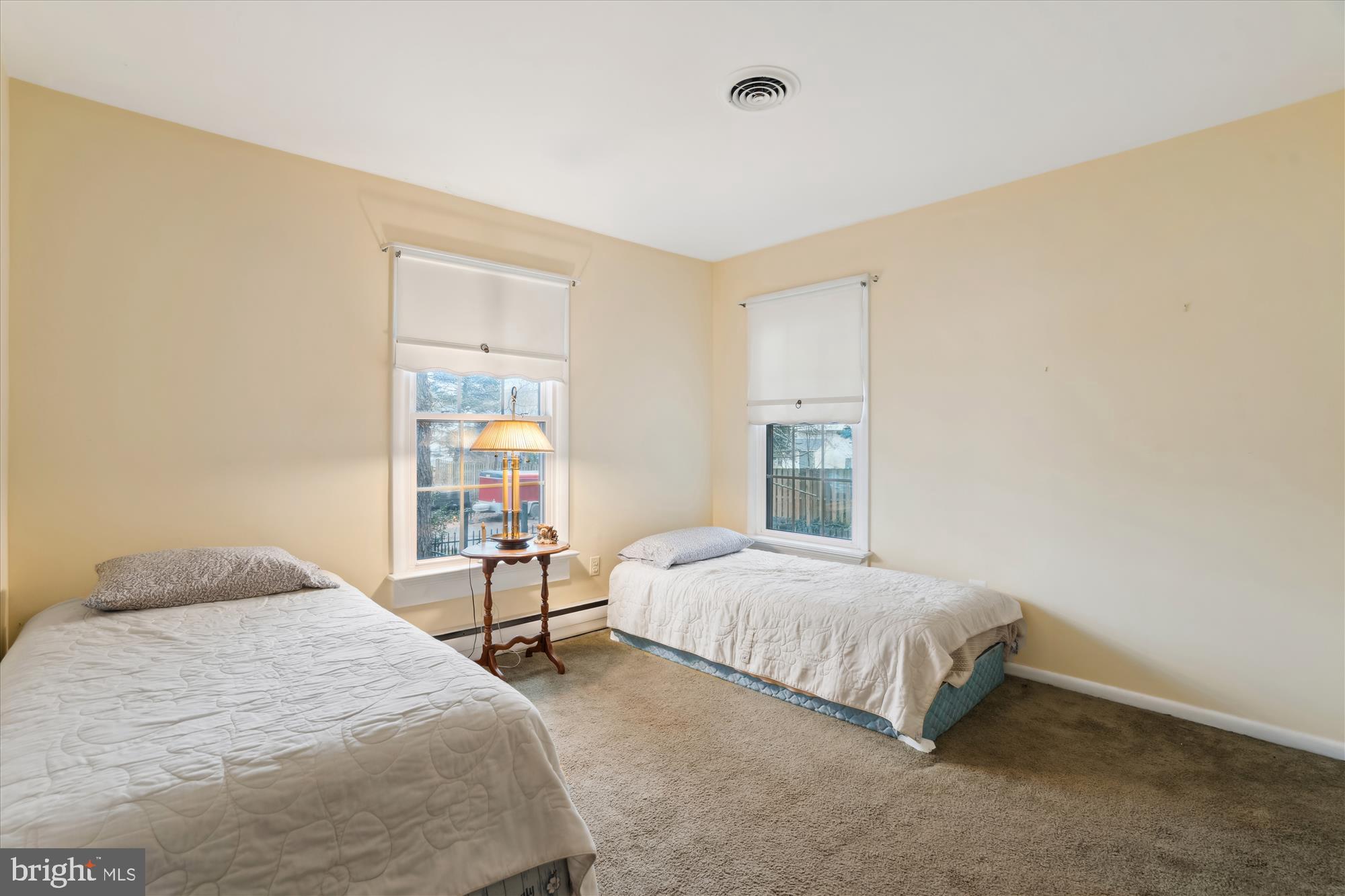 11319 Harding Road Laurel, MD 20723 - Photo 19 of 44 a bedroom with a bed and a table in it