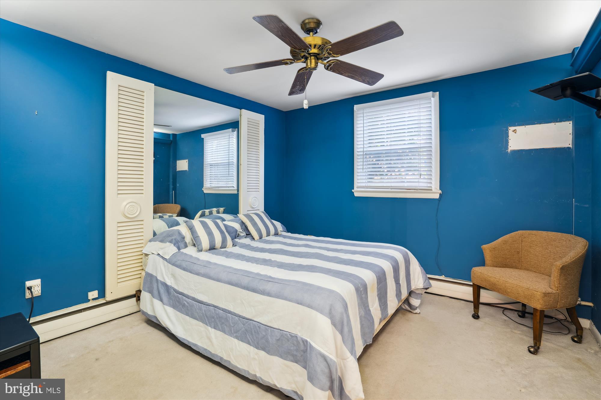 11319 Harding Road Laurel, MD 20723 - Photo 23 of 44 a bedroom with a bed a chair and a chandelier