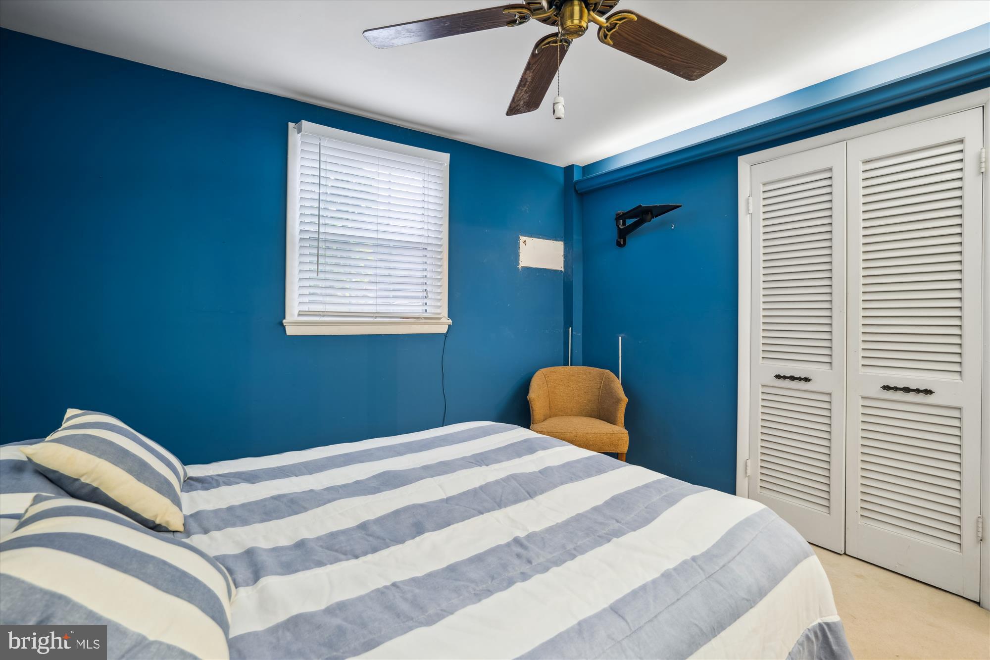 11319 Harding Road Laurel, MD 20723 - Photo 24 of 44 a bedroom with a bed and a chandelier