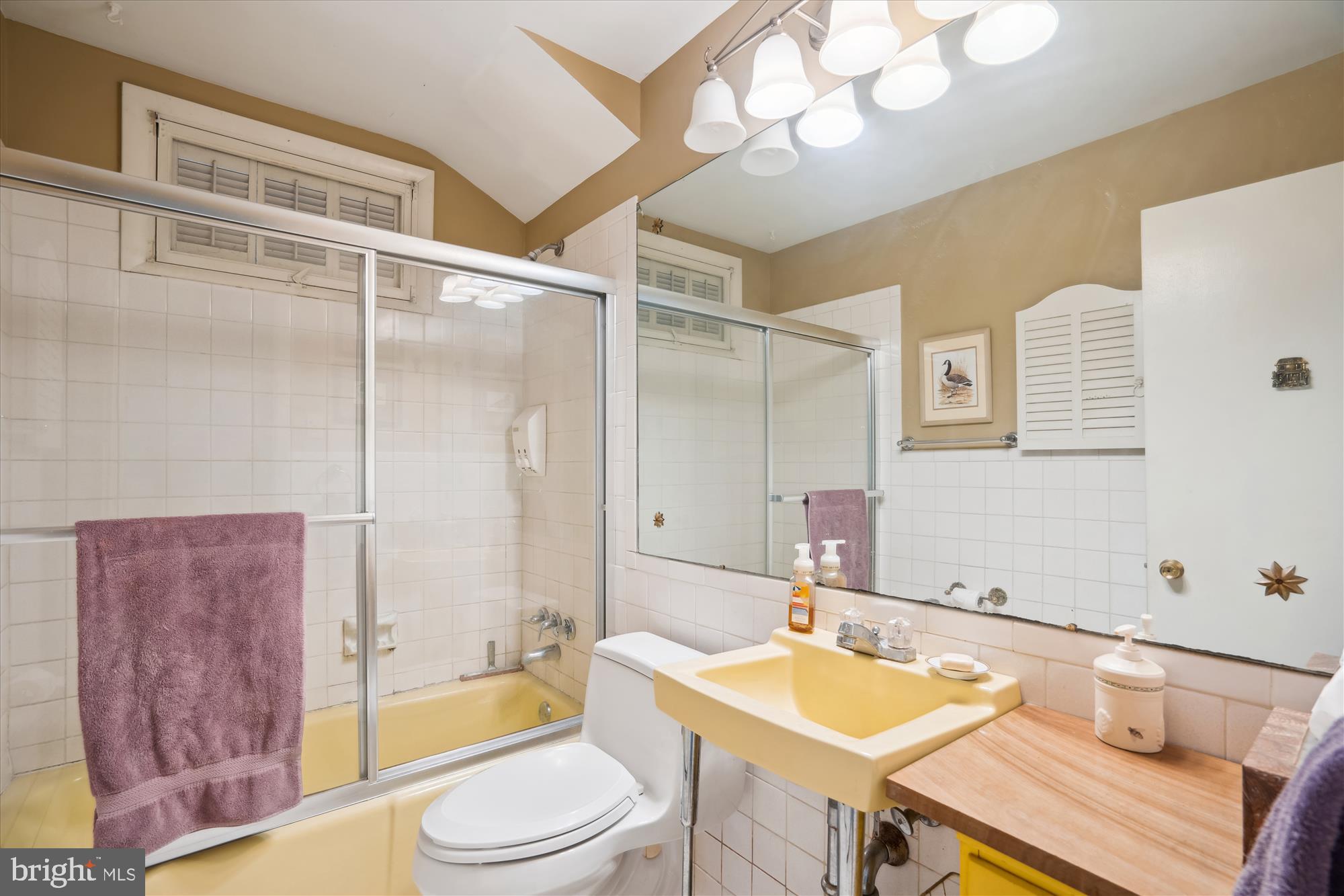 11319 Harding Road Laurel, MD 20723 - Photo 25 of 44 a bathroom with a granite countertop sink a toilet a mirror and bathtub