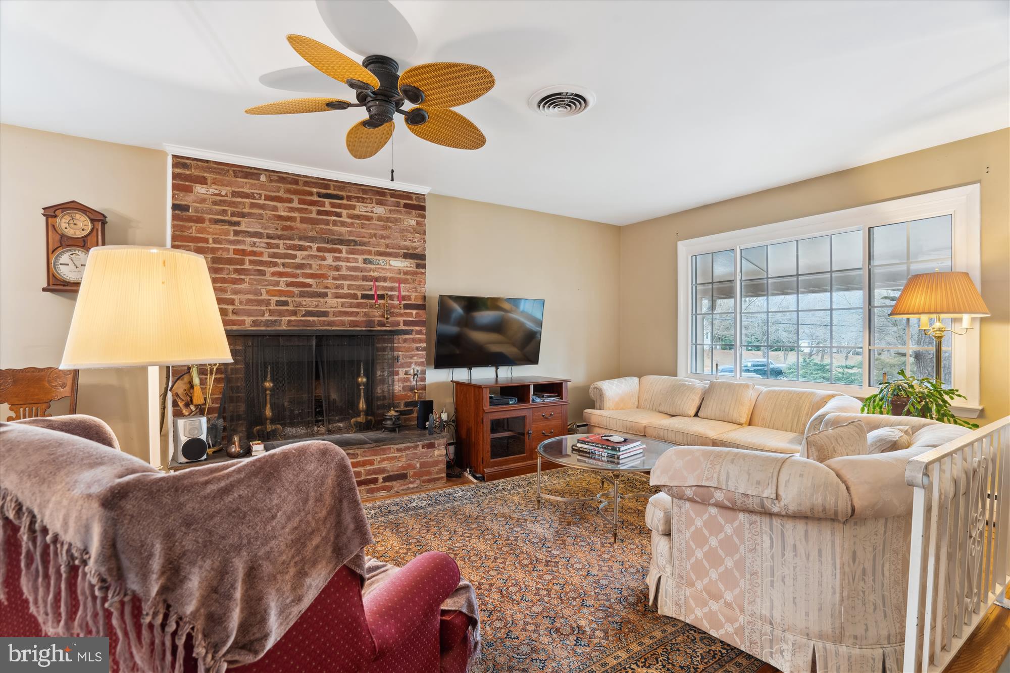 11319 Harding Road Laurel, MD 20723 - Photo 6 of 44 a living room with furniture a fireplace and a flat screen tv