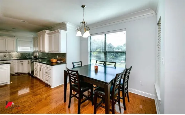 a kitchen with granite countertop white cabinets and stainless steel appliances