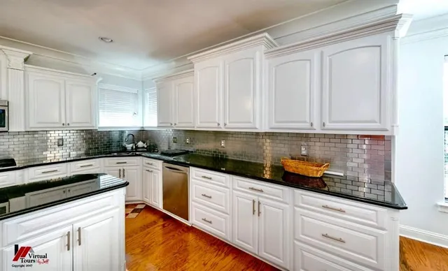 a kitchen with granite countertop white cabinets and white appliances