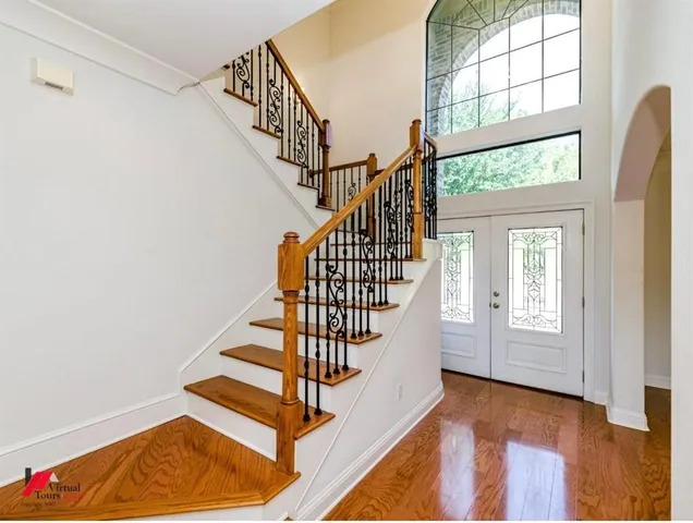 a view of entryway and hall with wooden floor